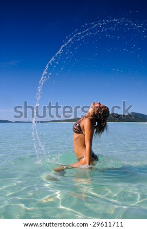 Girl splashing water with long hair