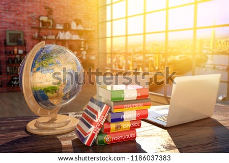 Languages learning and translate, communication and travel concept, books with covers in colors of flags of Europe countries, laptop and globe on a table in a modern interior, 3d illustration