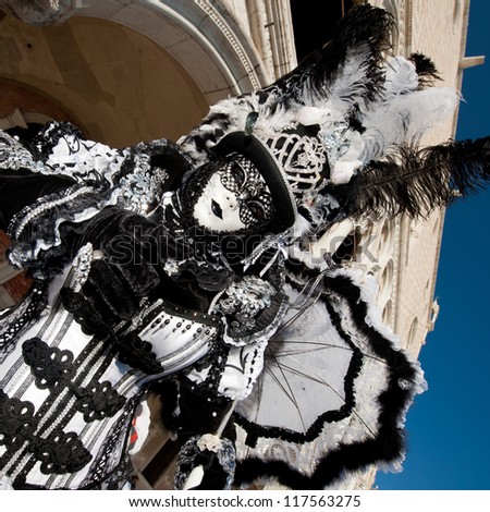 VENICE, ITALY - FEBRUARY 16: Unidentified person in Venetian masks at St. Mark\'s Square, Carnival of Venice on February 16, 2012. The annual carnival is from February 11 to February 21, 2012.