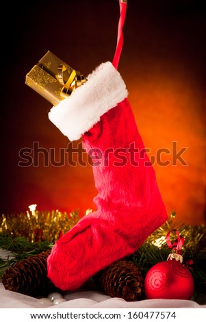 Christmas sock hanging over ornament arrangement