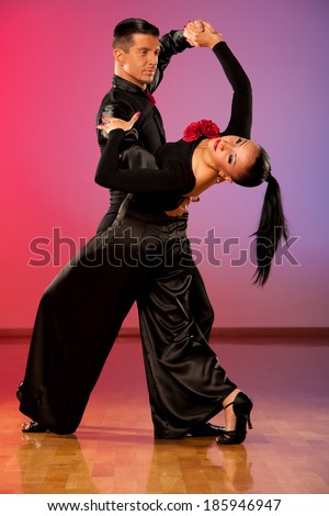 Professional ballroom dance couple preform an romantic exhibition dance