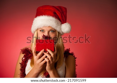 Attractive young blonde woman in santa claus dress