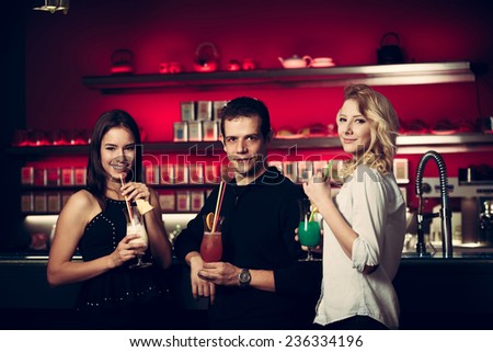A group of people drinking cocktail in a night club and having fun