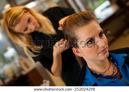 Young woman in hairdresser saloon having a haircut