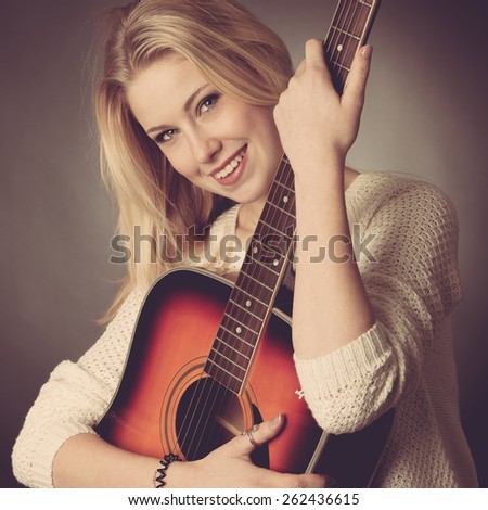studio Portrait of young blonde guitar player