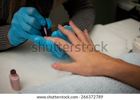 Making hand nails in a professional hand care salon