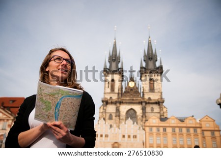 Beautiful young tourist woman photographing sites in Prague Czech republic