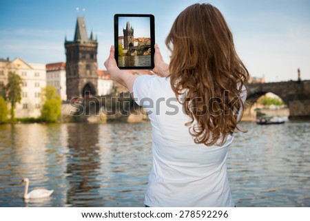 Beautiful young tourist woman photographing sites in Prague Czech republic