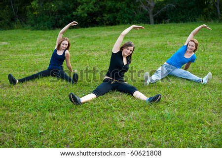 Three cute girls work out in nature