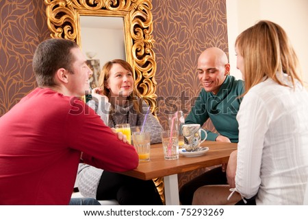 Four people having a debate in cafe
