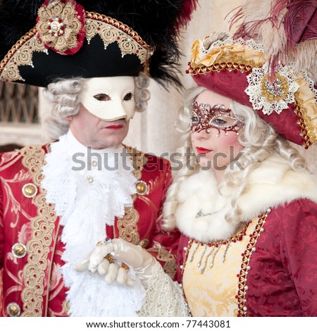 VENICE, ITALY - MARCH 7: Unidentified couple in Venice mask at St. Mark\'s Square, Carnival of Venice on March 7, 2011. The annual carnival was held in 2011 from February 26 to March 8, 2011.
