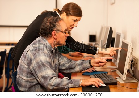 Group of adults learning computer skills. Intergenerational transfer of knowledge.