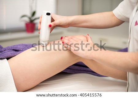 Hair removal cosmetology procedure from a therapist at cosmetic beauty spa clinic.