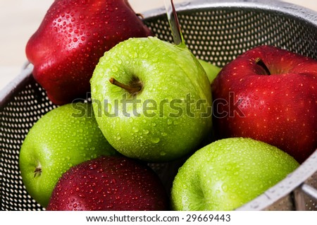 washing red and green apples under tap water