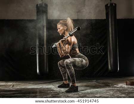 sporty girl squats with barbell training