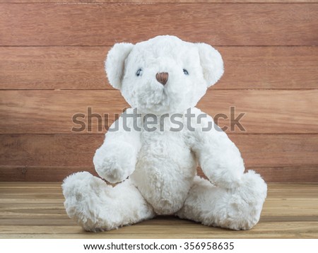 White bear doll on wooden table.