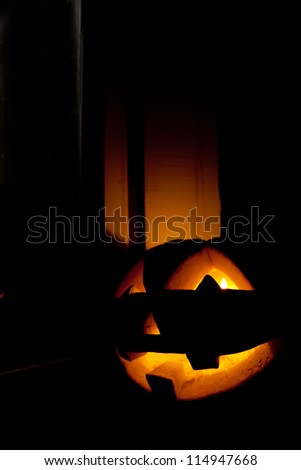 Jack-o\'-lantern, spooky Halloween pumpkin face glowing in the night