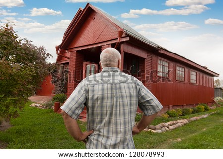 elderly man standing  back at the country house