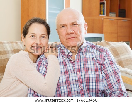 Happy middle-aged couple in  apartment