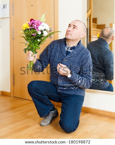 Marriage proposal. Adult man with flowers.