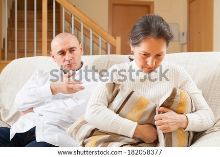 Family quarrel. Woman having problems with her husband at home