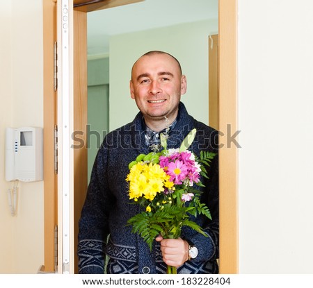 man with  beautiful bouquet near  front door
