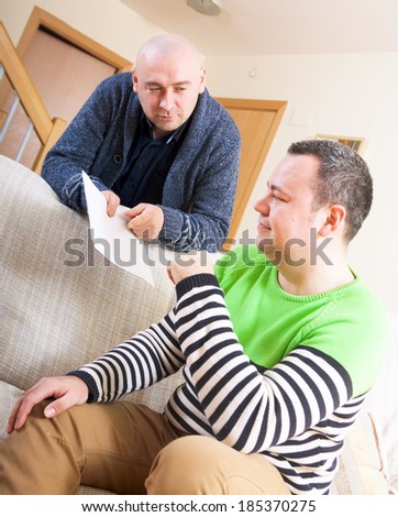 Two adult  friends  talking at home