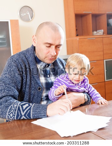 Father working with documents with daughter