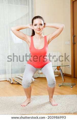 Brunette doing physical exercises at home