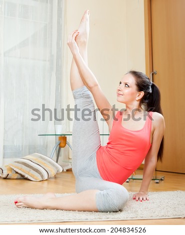 girl doing exercises of  yoga on  mat at home