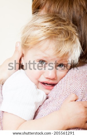Mom holding crying child in your arms