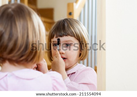 Little cute girl  with  makeup brush
