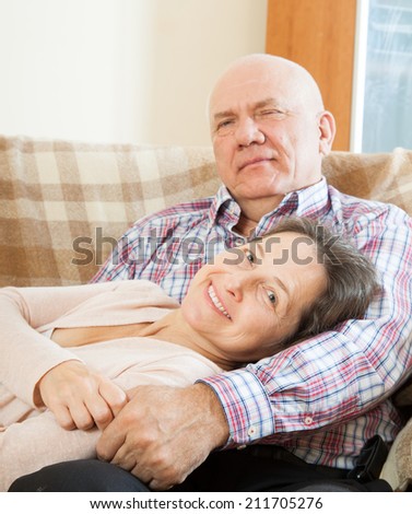 romantic couple relaxing on  couch at home