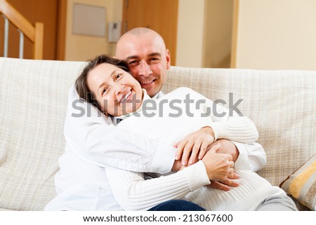 romantic couple relaxing on  couch at home