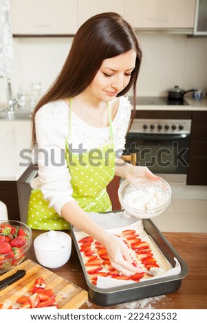Housewife cooking sweet cake in  kitchen.