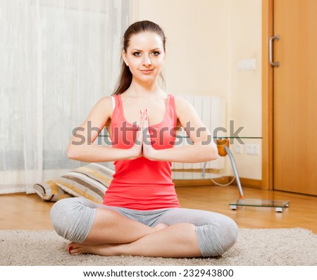 beautiful girl doing exercises of  yoga on  mat at home