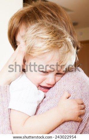 Mom holding  crying child in your arms
