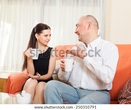 Woman and man   talking over   cup of tea.