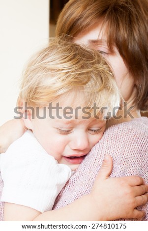 Mom holding  sad child in your arms