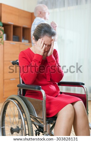 woman in   wheelchair and   elderly man in quarrel