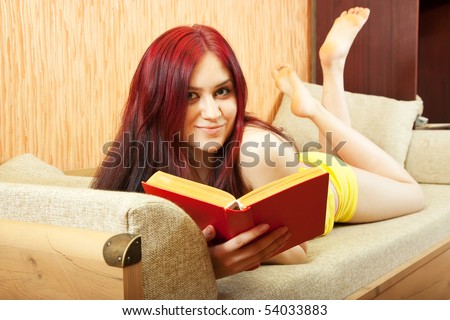 Pretty girl read red book on sofa