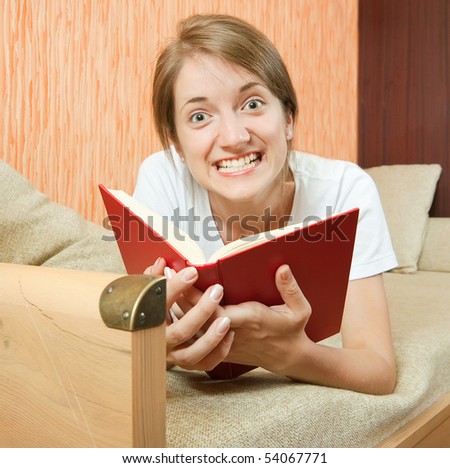 Emotion girl with book on beige couch