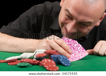 Stylish man in black shirt playing in casino poker at Las Vegas over black