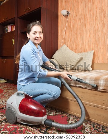 housekeeper. She is vacuuming the entry foyer into  home