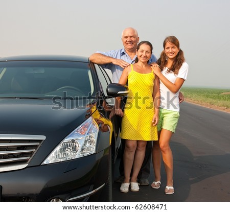 Family near black car at road outdoor