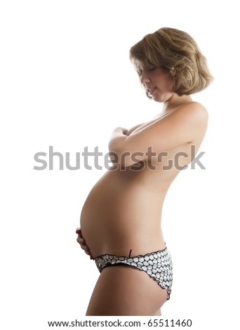 stock photo Portrait of a naked young pregnant woman holding her tummy 