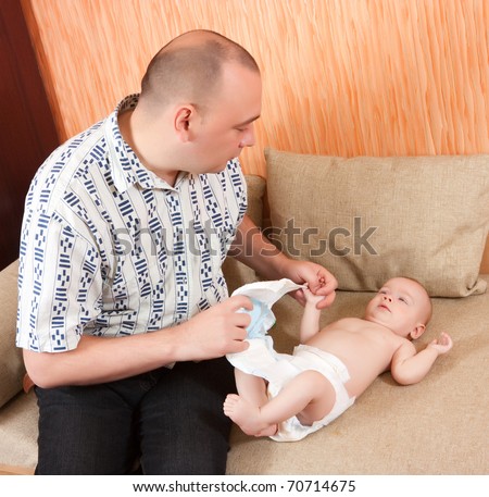 Dad is wondering what to do with little baby,