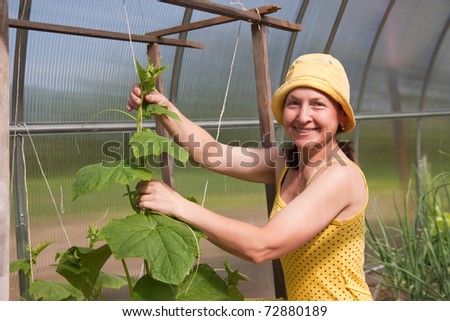 Mature lady taking care of her plants