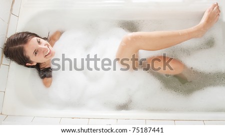 young beautiful girl in a bath with  foam