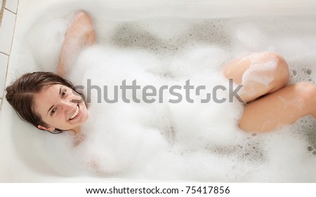 Portrait of the girl sitting in a bath